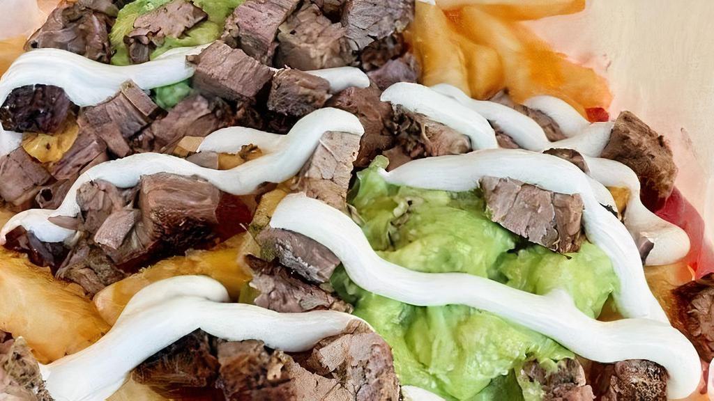 Carne Asada Fries · FLAMED GRILLED ANGUS STEAK (100% CERTIFIED ANGUS BEEF), FRIES, GUACAMOLE, SOUR CREAM & CHEESE