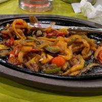 Fajitas · Beef, chicken, or shrimp. Grilled bell peppers, onions, and tomato.
Served with rice, beans,...