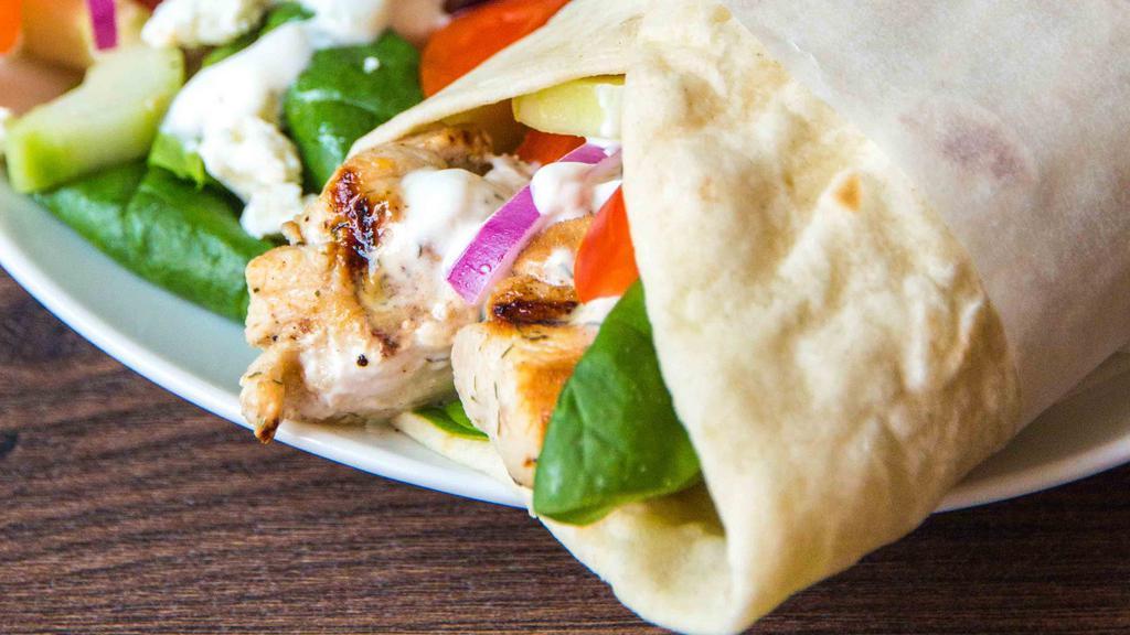 Chicken Kabob Wrap · Wrapped with lettuce, cucumbers, tomatoes, pickles, hummus spread, tahini and garlic sauce.