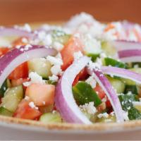 Greek Salad · Gluten free. Vegetarian. Chopped cucumbers, tomatoes, red onions, feta cheese and our house ...