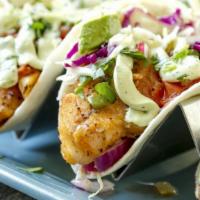 Grilled Fish Tacos · Two Mahi Mahi tacos topped with a cilantro, avocado cream, and pico de gallo, served with a ...