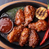 Fire Wings · Juicy chicken wings deep-fried and smothered in a spicy sauce.