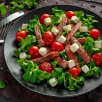 Fajita Steak Salad · Fresh salad made with slices of seasoned steak, roasted peppers and onions, and fajita seaso...