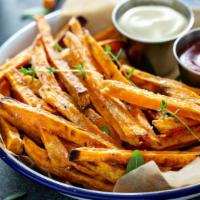 Sweet Fries · Basket of sweet potato fries with fresh seasonings.