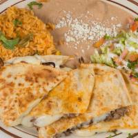Plato De Quesadilla · 13' flour tortilla with your choice of meat and mozzarella cheese includes rice, beans, and ...