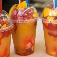 Mangoneada · Mango drink. Chamoy sauce, mangos, lime juice, and chili powder and is decorated with a tama...