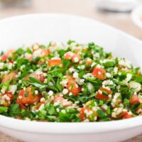 Tabbouli Salad · Tomatoes, finely chopped parsley, mint, bulgur, and onion, and seasoned with olive oil, and ...