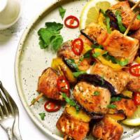 Salmon Kebab Plate · Tender salmon kebabs served with warm pita bread,  choice of rice or house salad, choice of ...