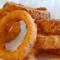 Beer Battered Onion Rings · Crispy buttered and seasoned onions served with house dip or ketchup Rings.