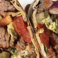 Steak Wrap · Toppings includes hummus, lettuce, tomato, grilled onion & chipotle tahini.