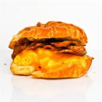 Meat Lovers Croissant Breakfast Sandwich · 2 scrambled eggs, melted Cheddar cheese, smoked
bacon, breakfast sausage, grilled onions, an...