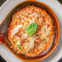 Melanzane Parmigiana  · Floured then fried eggplant layered with tomato sauce, mozzarella and basil and finished in ...