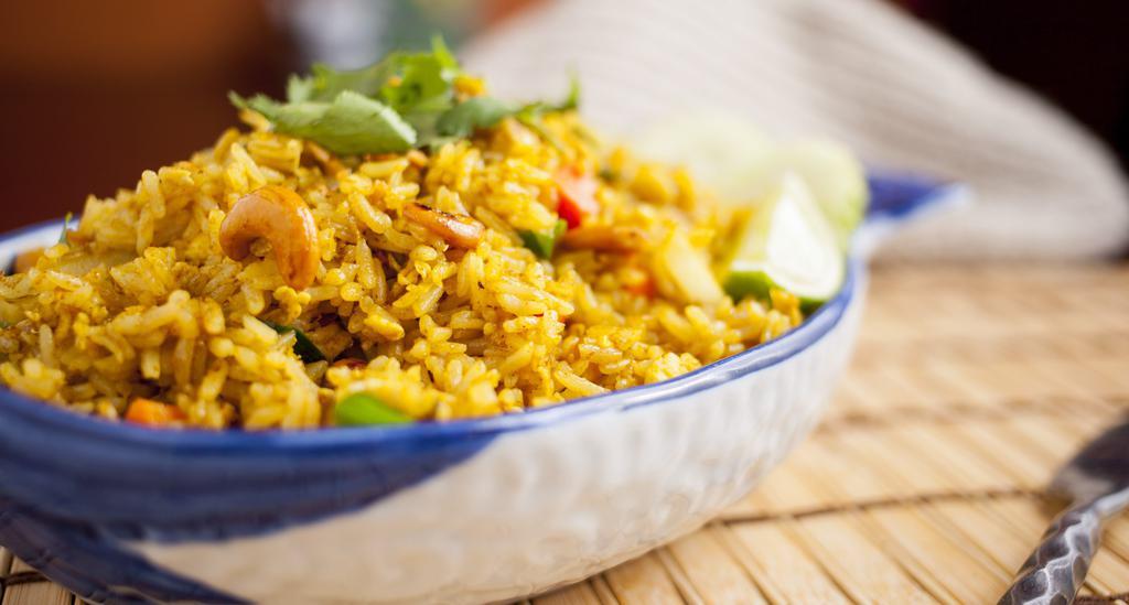 Pineapple Fried Rice · Favorite. Fried rice with sweet pineapple, cashew nut, white onion, green onion, tomato, egg, karee curry powder and carrot.