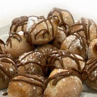 Nutella Bites · Baked to order dough bites smothered with Nutella and sprinkled with powdered sugar.
