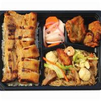 Grilled Liempo Bento Bx · Served with Pancit Bihon, Fish Fritters, Pickled Radish, and Rice.