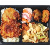 Breaded Pork Chop Bento Bx · Served with Pancit Bihon, Fish Fritters, Pickled Radish, and Rice.