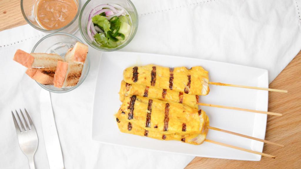 Chicken Satay (4 Pc) · Grilled marinated chicken skewer served peanut sauce and pickled cucumber salad on the side.