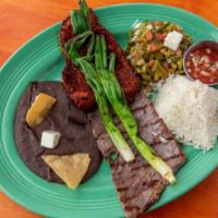 Carnes Monte Alban · Beef and pork with black bean paste, cactus salad and grilled onions. Served with rice.