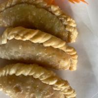 Empanadas · Potatoes, onions, peas, carrots, and yellow curry stuffed in a puff pastry. 
Served with cuc...