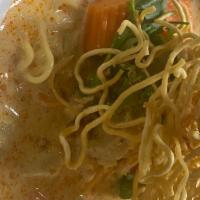 Kow Soi (Yellow Curry Noodles) · Spicy. Crispy noodles with carrots, white onions and chili oil in yellow curry sauce served ...