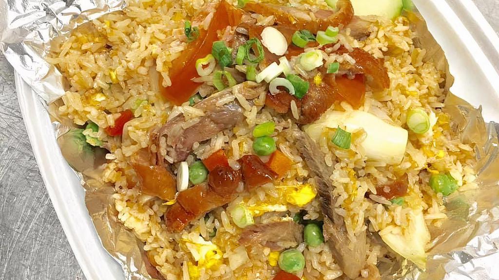 Duck Or Tilapia Fried Rice · Pan fried rice with egg, peas and carrots, onion, tomato and fresh cucumber.