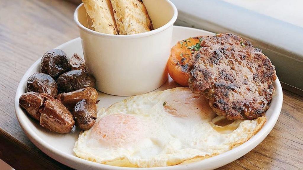 Breakfast Plate · Two eggs any style, maple breakfast sausage, mushroom gravy, smashed potatoes, tomato, rustic sourdough toast