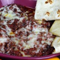 Queso Fundido · sautéed chorizo with melted Monterey Jack cheese and flour tortillas