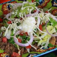 Taco Salad · Crispy Tortilla Chips with Ground Beef, Beans, Cheese, Pico de Gallo, Guacamole and Sour Cream