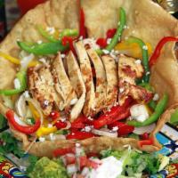 Chicken Fajita Tostada · A Charbroiled Chicken Breast served in a Flour Tortilla Basket filled with Greens, Grilled Y...