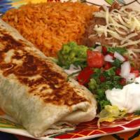 Tijuana Burrito · Steak or Chicken Fajitas Ingredients rolled into a large grilled Flour Tortilla,
with Sour C...