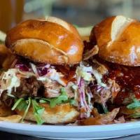 Pulled Pork Sliders · 2 Kahlua Pork Sliders with Coleslaw + Tempura Onions + Smokey BBQ Sauce + Pretzel Buns