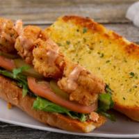 Shrimp Po' Boy · Eight crispy fried or grilled shrimp laid out on grilled garlic bread topped with mixed gree...