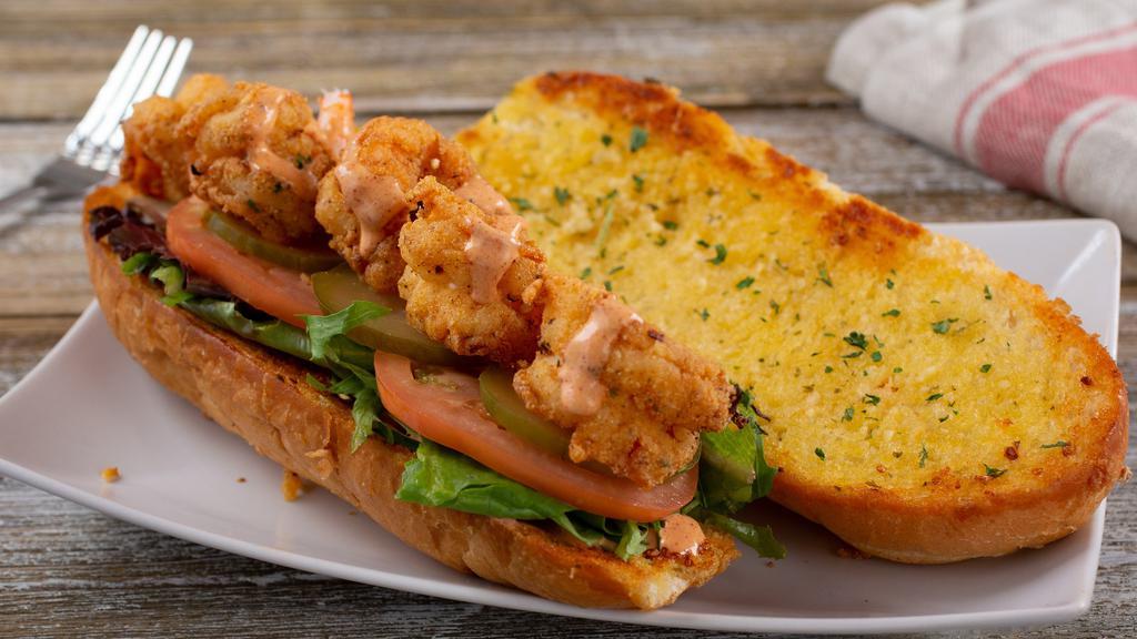 Shrimp Po' Boy · Eight crispy fried or grilled shrimp laid out on grilled garlic bread topped with mixed greens, tomatoes, pickles and creamy Cajun sauce.  Comes with French Fries.