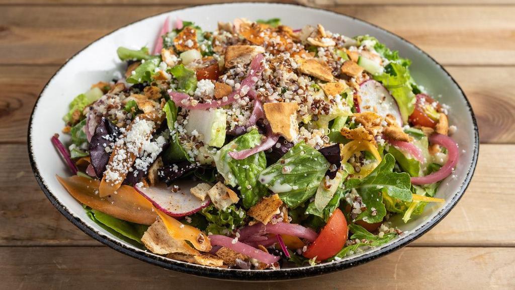 Quinoa Chop · field greens, quinoa, cherry tomatoes, cucumbers, radishes, pickled red onions, shaved carrots, toasted flatbread pieces, crumbled queso fresco, house-made lemon vinaigrette.