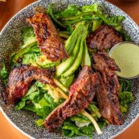 Steak Salad · grilled angus steak, romaine, avocado, candied pumpkin seeds, roasted poblano peppers, torti...