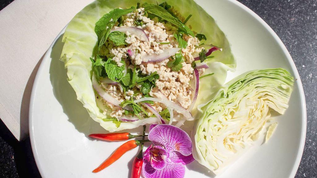 Lettuce Wraps · Minced chicken or tofu tossed with mint, chili, lime juice, and rice powder.  Served with fresh iceberg lettuce wraps.