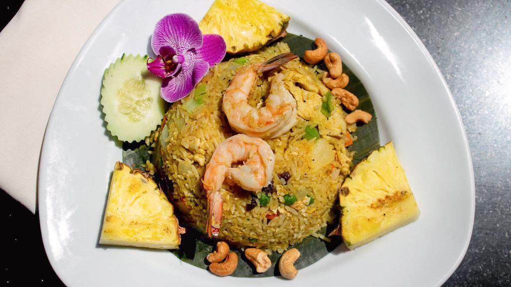 Islander Fried Rice · Jasmine rice stir-fried with shrimp, chicken, pineapple, egg, onions, tomatoes, raisins, and cashew nuts.