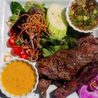 Crying Tiger · Grilled marinated beef tenderloin served with a spicy lime dipping sauce, and mixed greens.