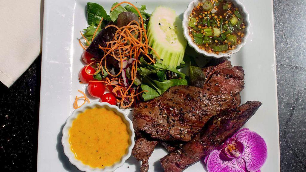 Crying Tiger Steak · Overnight marinating, and flash-fast cooking ensures the tender sirloin steak is extremely flavorful.  This succulent dish is served with a side of tiger sauce (mixture of fish sauce, lime juice, scallions, rice powder, and dried chili flakes).