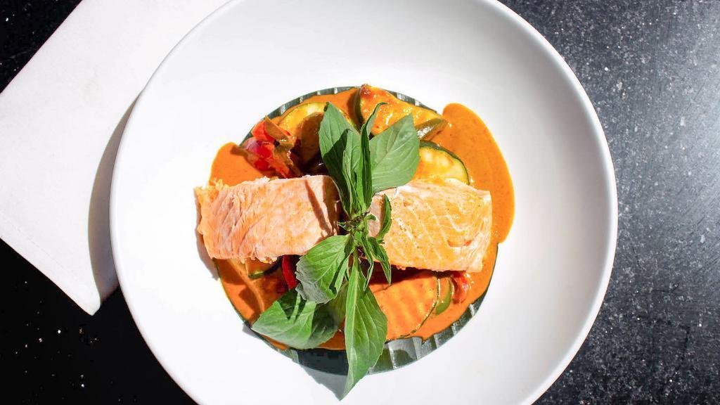 Salmon Panangcurry · This classic country-style dish is a thin soupy curry without coconut milk, but wonderfully strong flavors of spices and freshness.  Accompanied by bamboo shoots, peas, carrots, bell peppers, zucchini, and basil leaves.  Coconut milk free.