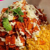 Chilaquiles · Crispy corn tortillas dipped in a green or red sauce. Topped with shredded chicken, sour cre...