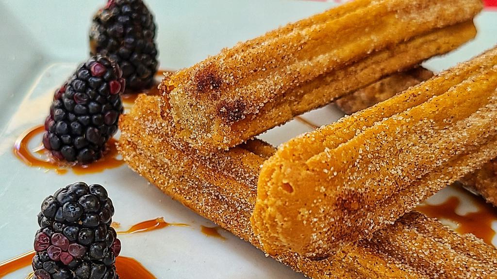 Churros · Churros rolled on cinnamon sugar, served with a side of Cajeta sauce.