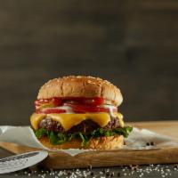 Cheeseburger · Black Angus ground beef burger on a sesame bun topped with cheddar, lettuce, tomatoes, white...