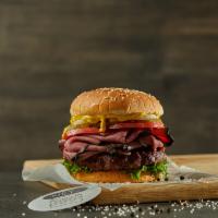 Pastrami Burger · Black Angus ground beef burger on a sesame bun topped with pastrami, white onions, pickles, ...