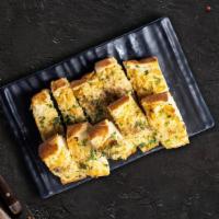 Gooey Garlic Bread · (Vegetarian) Housemade bread toasted and garnished with butter, garlic, mozzarella cheese, a...