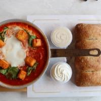 Halloumi Shakshuka · Crispy halloumi cheese and spinach, garnished with parsley & served with side salad. 

Consu...