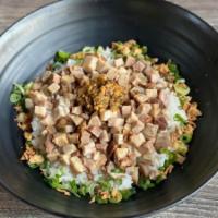 Spicy Chashu Bowl · Bowl of rice topped with crumbled pork chashu, green onion, and spicy takana ra-yu.