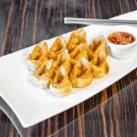 Wontons · Fried wontons filled with ground chicken and served with sweet chili sauce and peanuts.