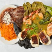 Molcajete · Servido con carne asada, pollo, camarones, queso, nopales y salsa verde / Serve with grilled...