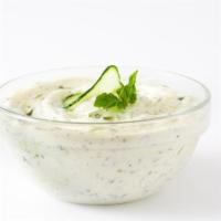 Tzatziki · Savory yogurt based sauce with cucumbers, garlic, lemon juice, and traditional herbs.